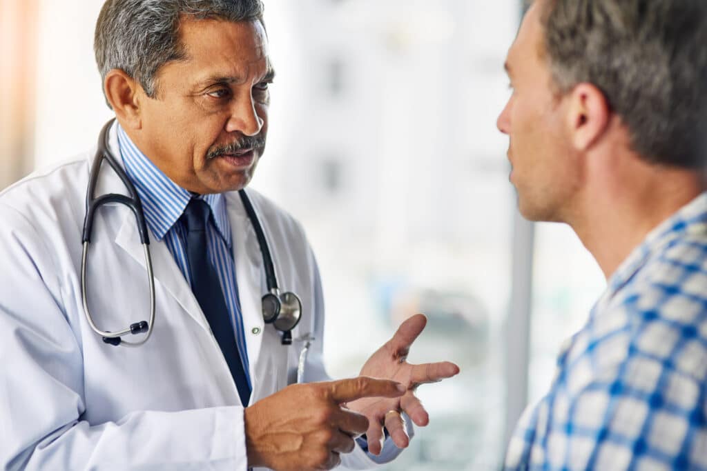 A doctor giving advice to a male patient